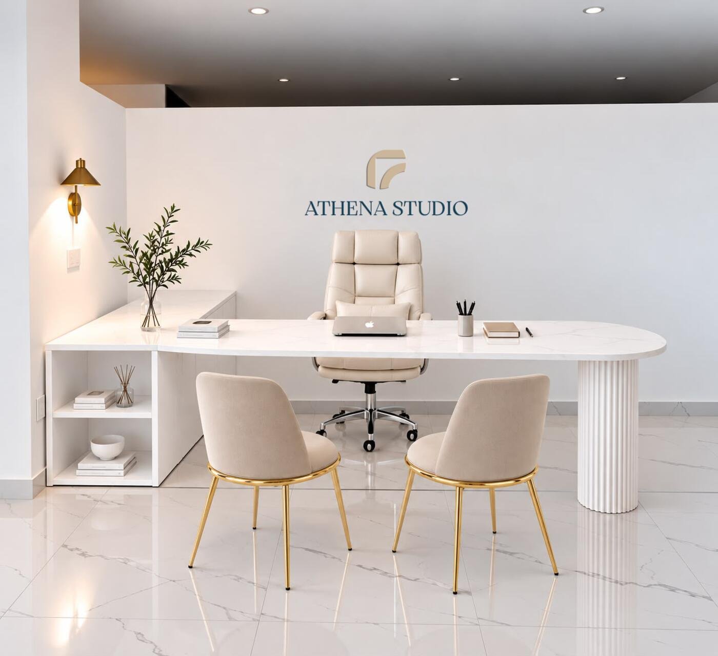 Interno di Athena Studio a Scalea: scrivania bianca, sedute color sabbia e logo dello studio a parete